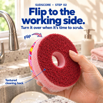 Pink Ring Donut turned over to reveal its burgundy textured cleaning back, pink porous body, and open center hole.