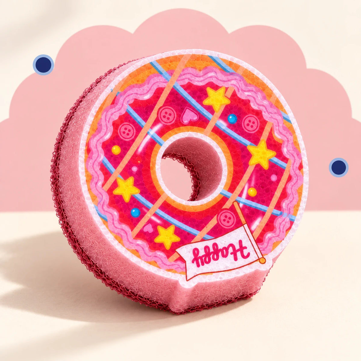 Pink Ring Donut cleaning sponge with flat printed stars and crossing lines, pink foam body, and visible thickness.